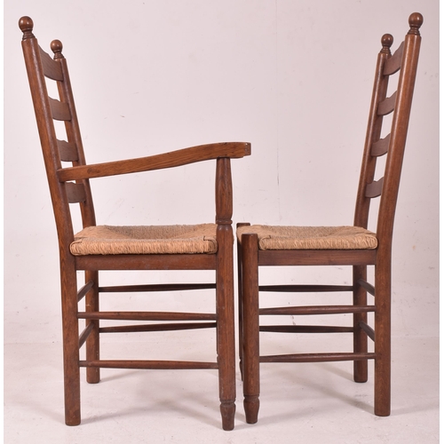 353 - A matching set of eight 20th century oak and rush seated North Country ladderback dining chairs. Eac... 