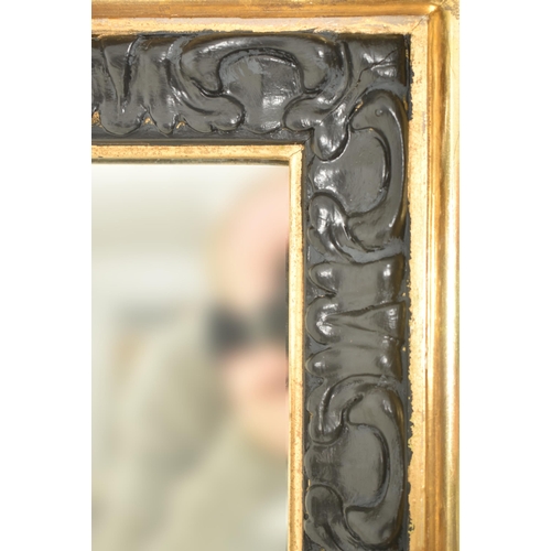 370 - A large 19th century Victorian gilt and ebonised wood overmantel mirror. The mirror of rectangular f... 