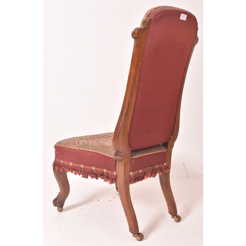 377 - A 19th century carved mahogany & tapestry needlepoint upholstery nursing chair. The chair having... 