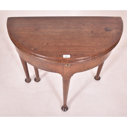 382 - A George III 18th century mahogany demi-lune folding card / game table. The table having a folding h... 