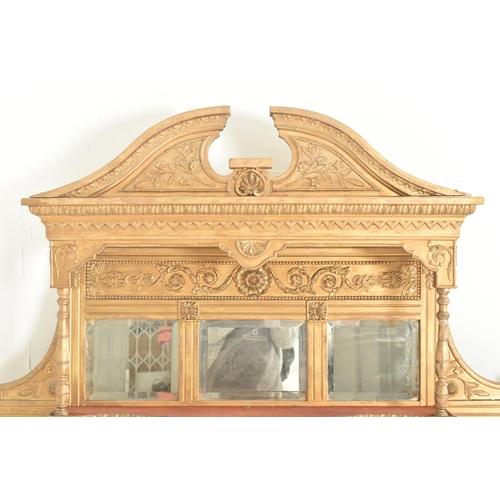 387 - An early 20th century gilt wood over mantel mirror shelf. The mantel mirror having a hood pediment a... 