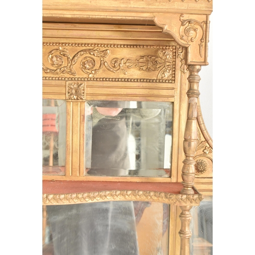 387 - An early 20th century gilt wood over mantel mirror shelf. The mantel mirror having a hood pediment a... 