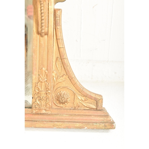 387 - An early 20th century gilt wood over mantel mirror shelf. The mantel mirror having a hood pediment a... 