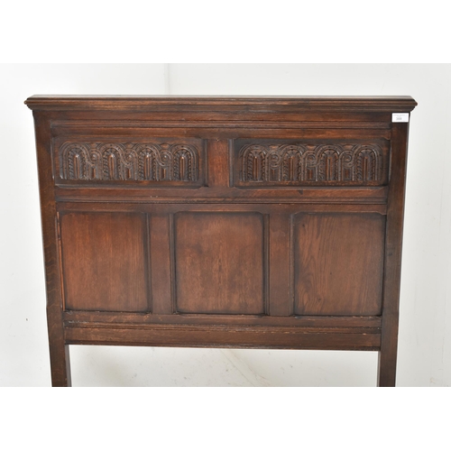 388 - A 17th century commonwealth revival oak single bed. The bed having matching head and footboard with ... 