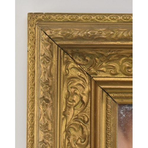 419 - A late 19th century giltwood cassetta wall hanging mirror. The mirror having carved foliate moulding... 