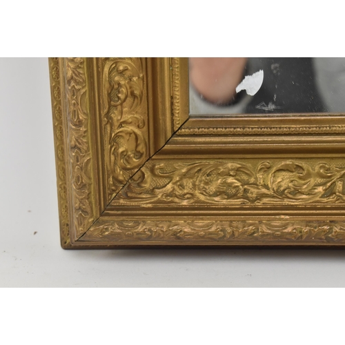 419 - A late 19th century giltwood cassetta wall hanging mirror. The mirror having carved foliate moulding... 