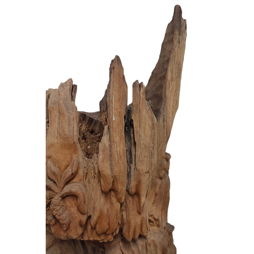 428 - A Polynesian inspired bespoke hand made carved tree trunk decorative sculpture. The tree trunk decor... 