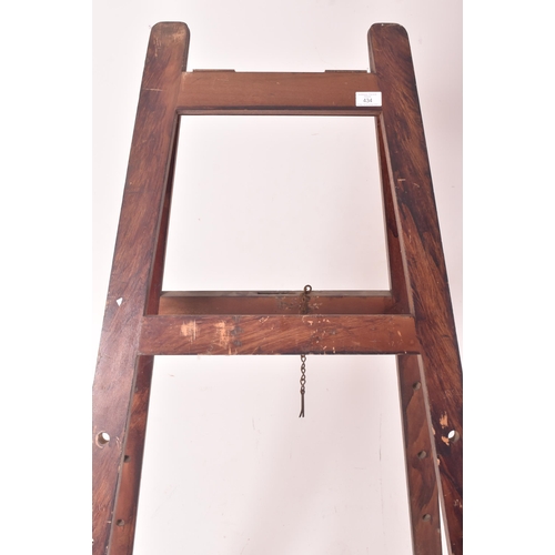 434 - A large early 20th century oak artist's folding easel with adjustable pegs. The easel having four sq... 