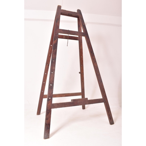 434 - A large early 20th century oak artist's folding easel with adjustable pegs. The easel having four sq... 