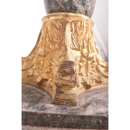 443 - An Italian inspired green marble and gilded metal turned column stand. The column having an octagona... 