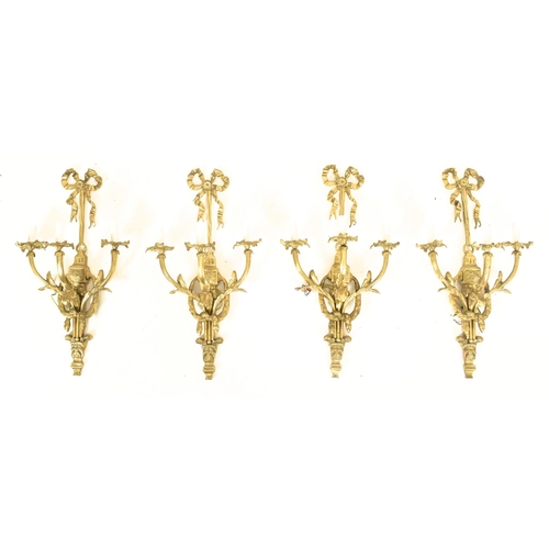 446 - A set of four French Louis XVI inspired gilt metal three arm decorative wall sconces lights. Each ha... 