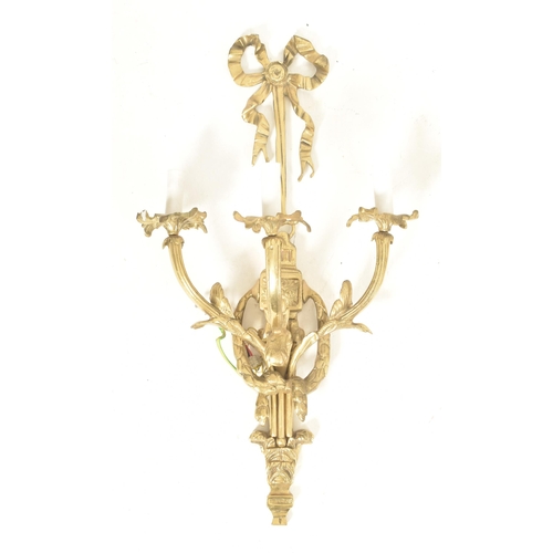 446 - A set of four French Louis XVI inspired gilt metal three arm decorative wall sconces lights. Each ha... 