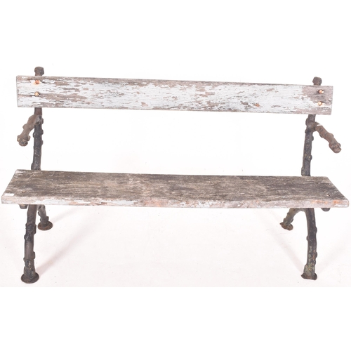 455 - A 19th century Victorian cast iron two seater garden bench. The bench with wooden seat and backrest,... 