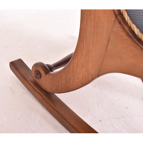 471 - A Victorian 19th century mahogany and upholstered slipper back low rocking chair. The chair having a... 