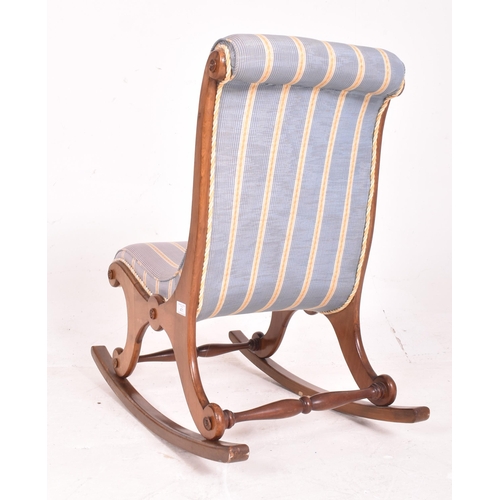 471 - A Victorian 19th century mahogany and upholstered slipper back low rocking chair. The chair having a... 