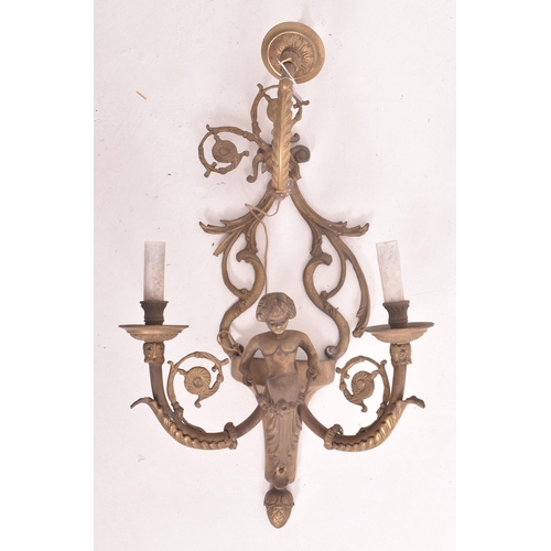 472 - A French Louis XVI style 20th century brass cherub wall sconce light. The sconce having a ram head s... 