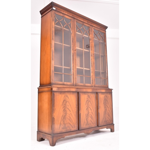 481 - A large George III Revival flame mahogany triple section three door astragal glazed bookcase library... 