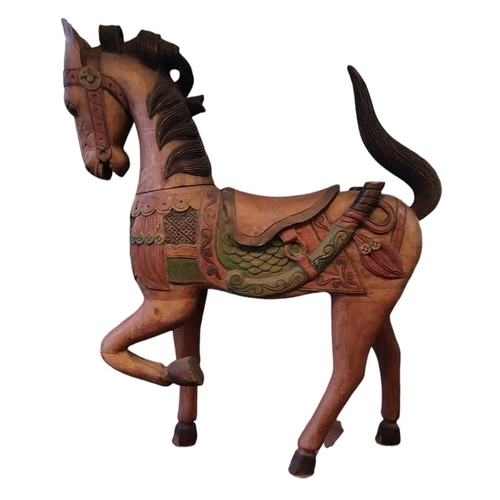 483 - A vintage 20th century Midlle Eastern inspired hand painted carved wooden carousel style horse. The ... 