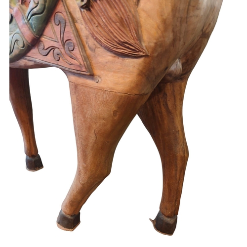 483 - A vintage 20th century Midlle Eastern inspired hand painted carved wooden carousel style horse. The ... 