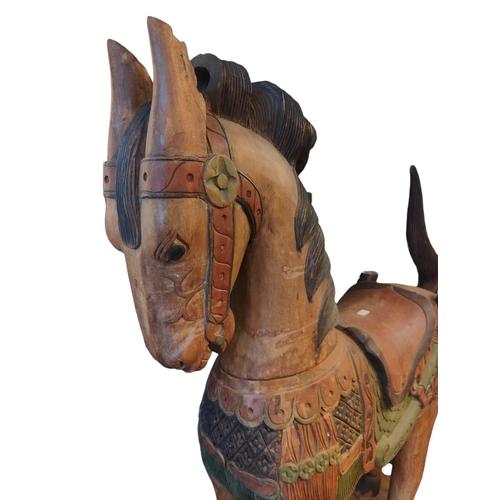 483 - A vintage 20th century Midlle Eastern inspired hand painted carved wooden carousel style horse. The ... 