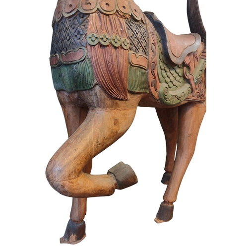 483 - A vintage 20th century Midlle Eastern inspired hand painted carved wooden carousel style horse. The ... 