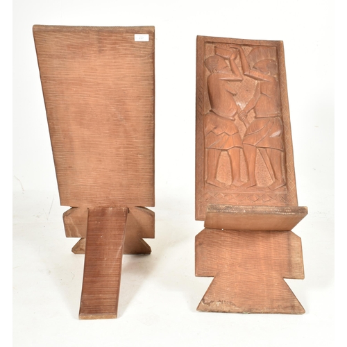 497 - A pair of 20th century hardwood Tribal African birthing chairs. Each chair being formed of two inter... 