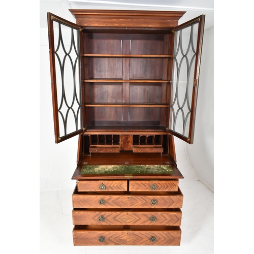 510 - A 19th century figured walnut veneered writing bureau bookcase. The bookcase top having a pediment a... 