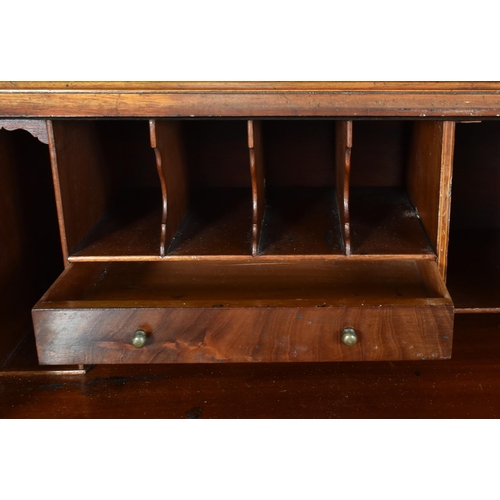 510 - A 19th century figured walnut veneered writing bureau bookcase. The bookcase top having a pediment a... 