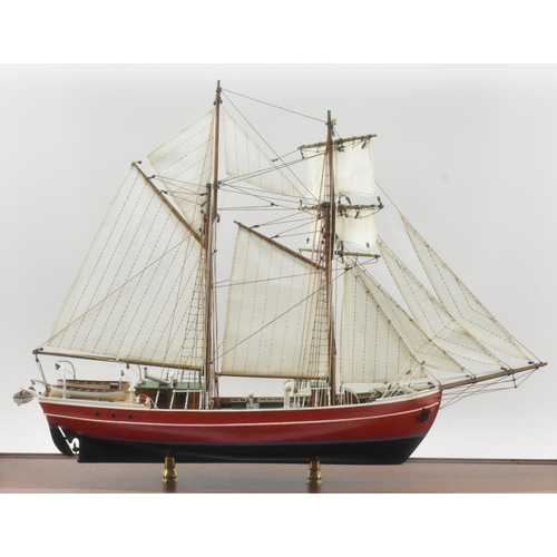 511 - An early 20th century hand built model sailing vessel - boat in glazed display cabinet. The boat pos... 