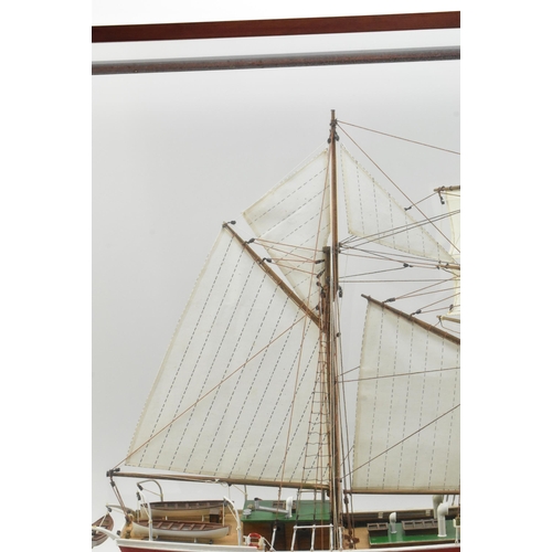 511 - An early 20th century hand built model sailing vessel - boat in glazed display cabinet. The boat pos... 