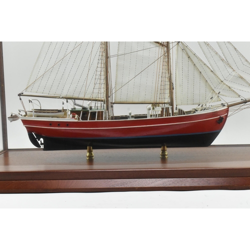 511 - An early 20th century hand built model sailing vessel - boat in glazed display cabinet. The boat pos... 