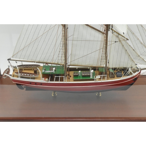 511 - An early 20th century hand built model sailing vessel - boat in glazed display cabinet. The boat pos... 