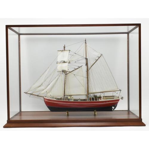 511 - An early 20th century hand built model sailing vessel - boat in glazed display cabinet. The boat pos... 