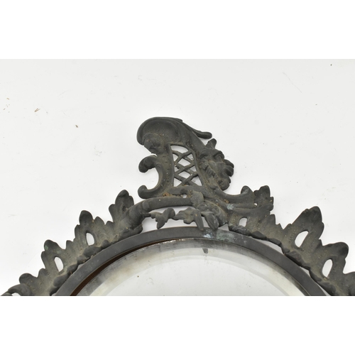 516 - A Victorian mid 19th century Gothic style cast iron wall mirror. The mirror with scrolled and foliat... 