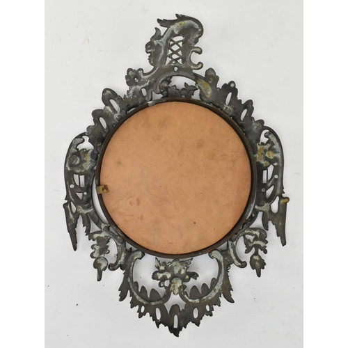 516 - A Victorian mid 19th century Gothic style cast iron wall mirror. The mirror with scrolled and foliat... 