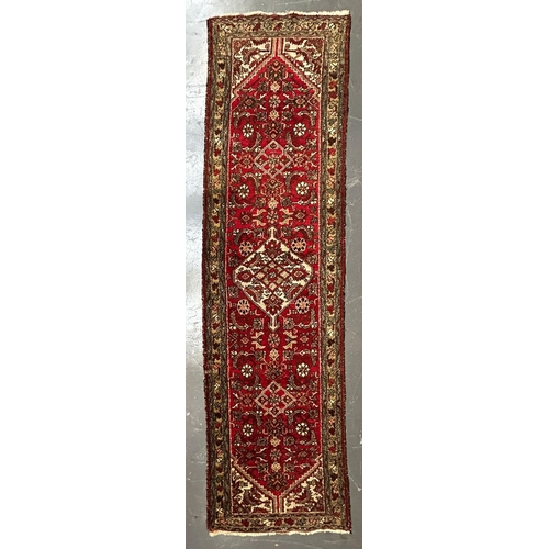 524 - An early 20th century Persian Islamic Bijar floor carpet runner rug. The runner having a red ground ... 