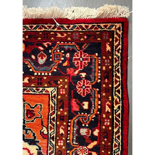 531 - A 20th century North West Persian Islamic Sarouk floor carpet rug. The rug having a diamond shaped c... 