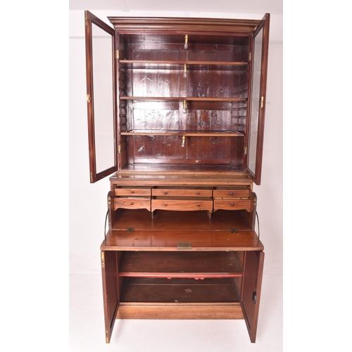 556 - An early 19th century Sheraton Revival mahogany secretaire bookcase. The bookcase having a flared pe... 