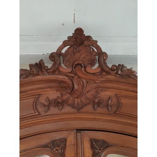 559 - A French 19th century Louis XV style kingwood mirror front armoire wardrobe. The wardrobe having a c... 