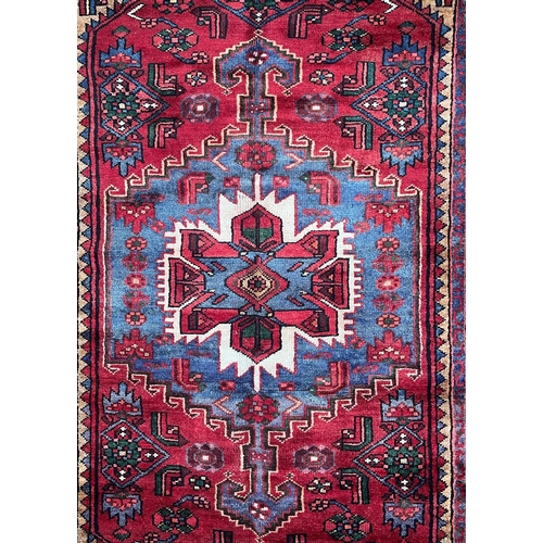 561 - An early 20th century North West Persian Islamic Zanjan floor carpet rug. The rug a series of centra... 