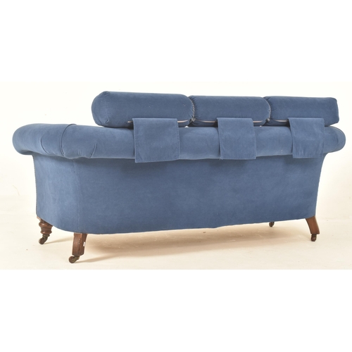 564 - A Victorian 19th century blue velvet upholstered Chesterfield seater sofa. The sofa raised on turned... 