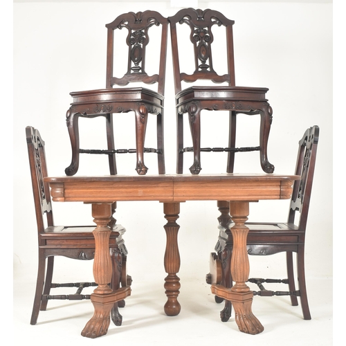 569 - A French continental early 20th century carved oak extending dining table together with a set of fou... 