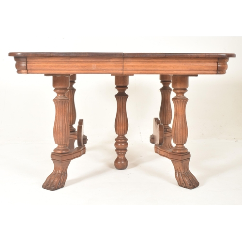 569 - A French continental early 20th century carved oak extending dining table together with a set of fou... 