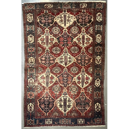 571 - An early 20th century Persian Islamic Bakhtiari hand woven floor carpet rug. The rug having a centra... 