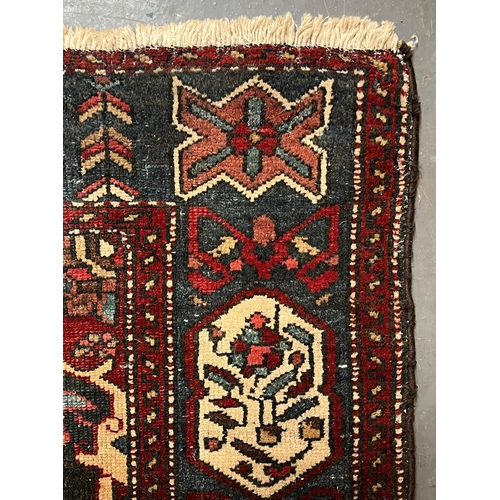 571 - An early 20th century Persian Islamic Bakhtiari hand woven floor carpet rug. The rug having a centra... 