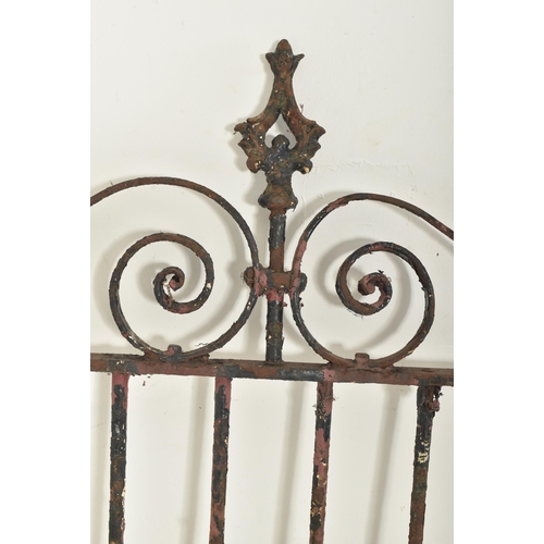 577 - A 19th century cast iron gate door. The gate having scrolled decorations atop with shaped finials to... 