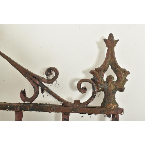 577 - A 19th century cast iron gate door. The gate having scrolled decorations atop with shaped finials to... 