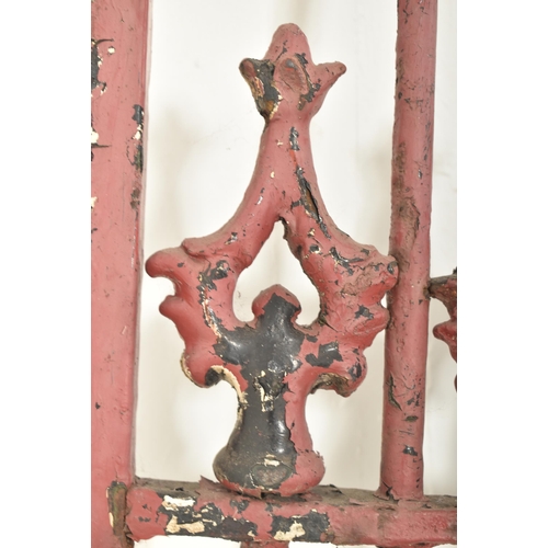 577 - A 19th century cast iron gate door. The gate having scrolled decorations atop with shaped finials to... 