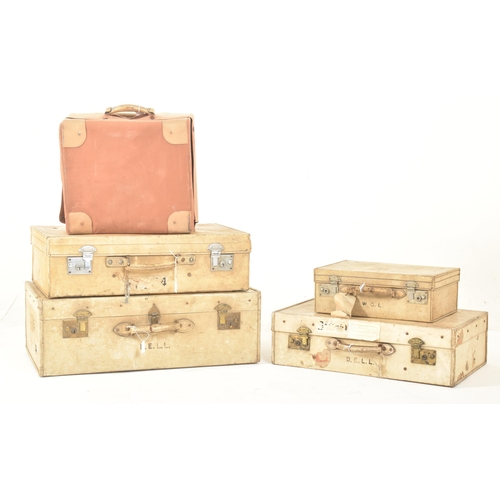 581 - A set of four early 20th century paper vellum style cream decorative travelling suitcases in varying... 