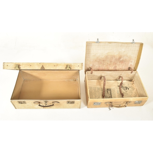 581 - A set of four early 20th century paper vellum style cream decorative travelling suitcases in varying... 